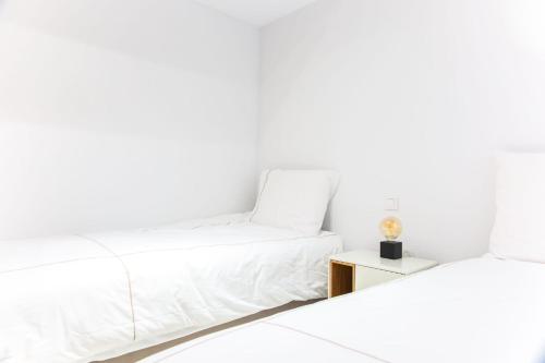 a white living room with a couch and a table at Calpe Bay in Calpe