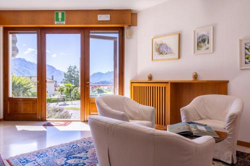 a living room with two chairs and a window at Hotel Royal in Menaggio