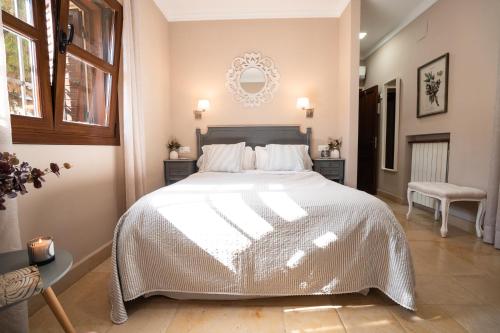 a bedroom with a large bed with a white comforter at Hotel Azalea Playa in Chiclana de la Frontera