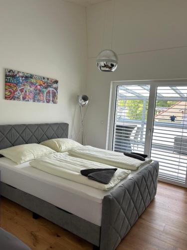 a large bed in a bedroom with a large window at LUX PENTHOUSE Klopeiner See Apartment Ferienwohnung FeWo in Sankt Kanzian