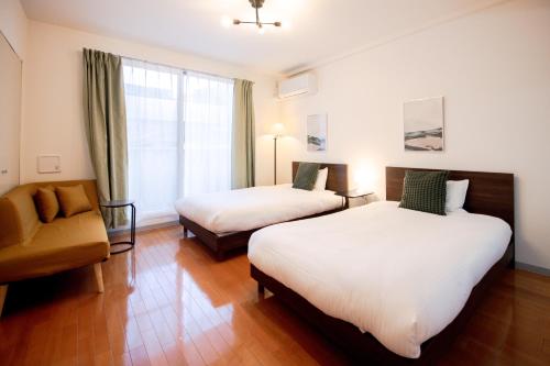 Postel nebo postele na pokoji v ubytování GuestHouse MIYABI