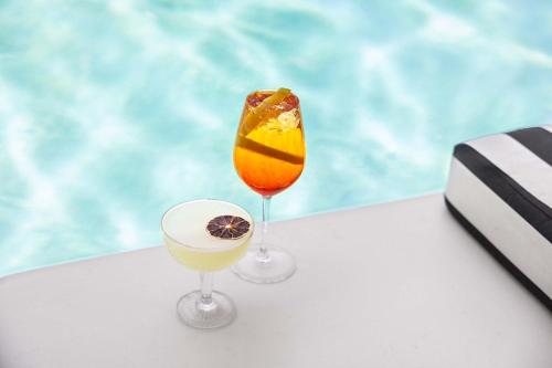 two glasses of drinks sitting on top of a table at Peppers Beach Club in Port Douglas