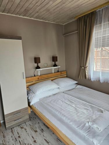 a bedroom with two beds and a window at Villa Szófia in Siófok