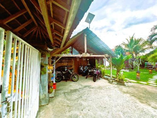 a group of motorcycles parked outside of a building at Ayumar Homestay Medewi in Pulukan