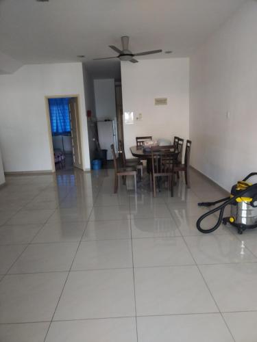 a living room with a dining room table and chairs at Homestay Atok Komando Bc Poly KB in Ketereh