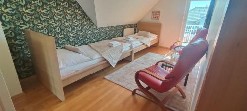 a living room with a couch and a chair at Hotel Orlan in Bratislava