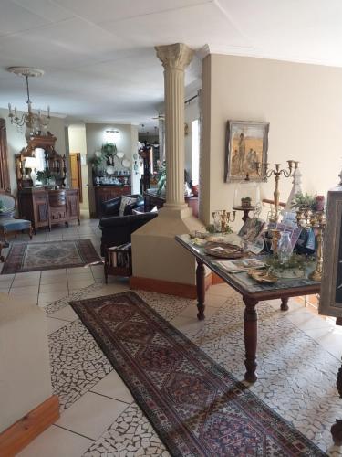 a living room with a table and a couch at Belvedere-on-River in Malelane