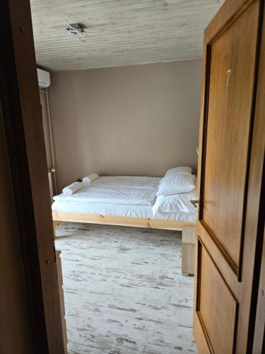 a bedroom with a bed in the middle of a room at Villa Szófia in Siófok