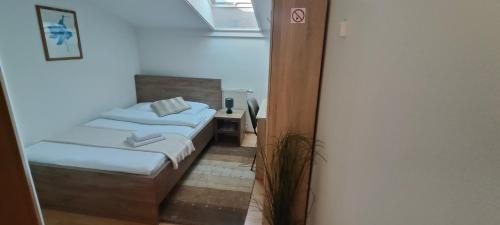 a bedroom with two beds in a room with a window at Hotel Orlan in Bratislava