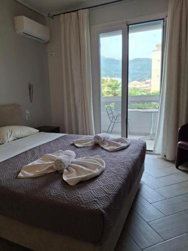 Postel nebo postele na pokoji v ubytování Palmyra Hotel