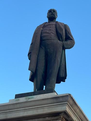 a statue of a man standing on top of a building at La Casa del Moro in Favignana