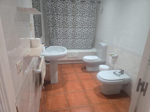 a bathroom with two toilets and a sink and a shower at Casa de la Hiedra Soria in Soria