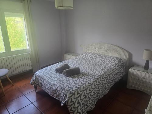a bedroom with a bed with two pillows on it at Casa de la Hiedra Soria in Soria
