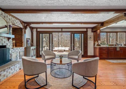 a living room with a table and some chairs at Unique Estate 5 Bedrooms Fire Pit Sleeps 10 in Akron