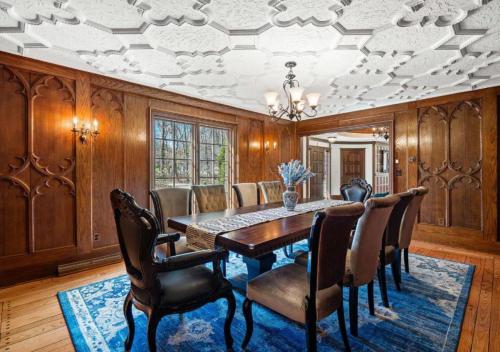 a dining room with a table and chairs at Unique Estate 5 Bedrooms Fire Pit Sleeps 10 in Akron