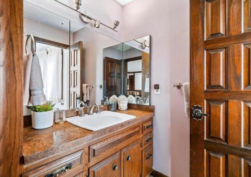 a bathroom with a sink and a large mirror at Unique Estate 5 Bedrooms Fire Pit Sleeps 10 in Akron