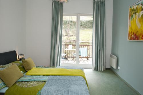 a bedroom with a bed and a balcony at Haus Zinnauer in Velden am Wörthersee