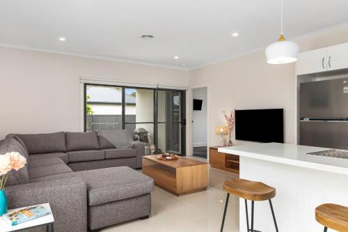 a living room and kitchen with a couch and a table at Getaway on Wallace - Fantastic central location in Mount Gambier