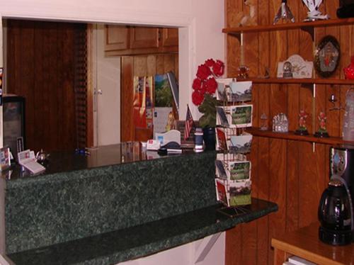 a kitchen with a counter and a counter top at Red Carpet Inn & Suites Morgantown in Morgantown