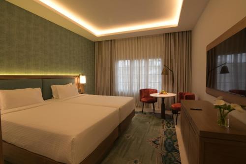 a hotel room with a bed and a table at Hotel Yak & Yeti in Kathmandu