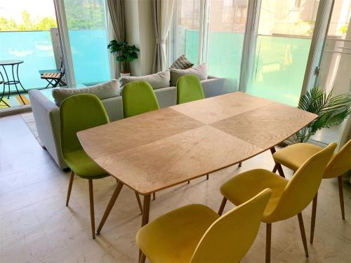 a table and chairs in a living room with a couch at O2 capsule house OTARU in Otaru