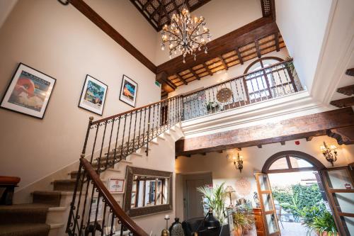 a staircase in a house with a chandelier at Hotel Azalea Playa in Chiclana de la Frontera