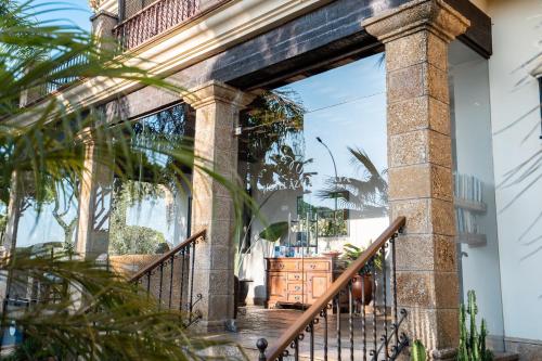 an entryway to a house with a stone wall and a staircase at Hotel Azalea Playa in Chiclana de la Frontera