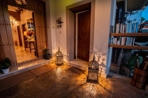 a hallway with two candle holders in front of a door at Hotel Azalea Playa in Chiclana de la Frontera