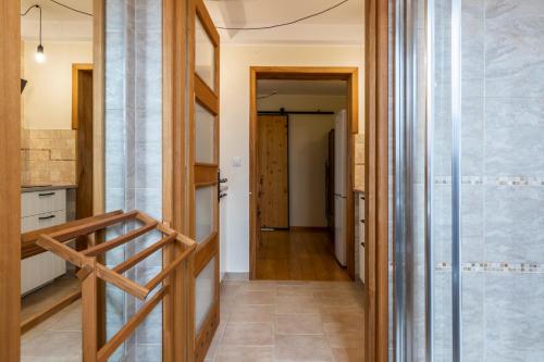 a hallway of a house with a staircase and a kitchen at TatryTop Apartamenty Pardałówka in Zakopane