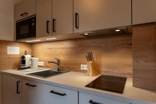 a kitchen with a sink and a counter top at Pension Bergbauernhof Irxner in Schladming