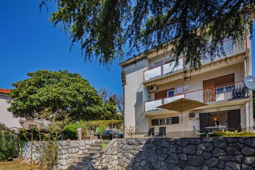 a building with a stone wall in front of it at The Wave - Apt with Seaview and Garden - Happy Rentals in Kostrena