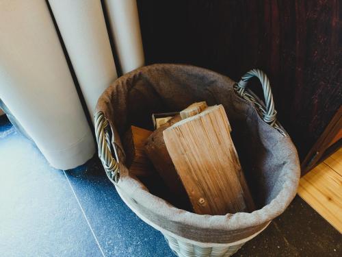 a basket with a wooden box in it on the floor at Charmantes Karwendel-Chalet in Wattens