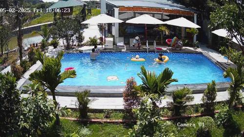 a large swimming pool with people in it at Hang Mua Luxury Homestay in Xuân Sơn