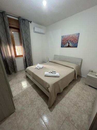 a bedroom with a bed with two towels on it at Istella in Posada