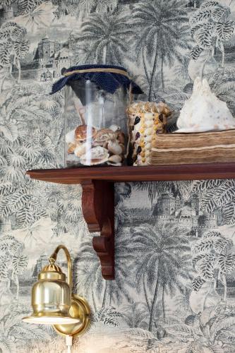 a shelf with cookies and other items on a wall at Strandflickornas Havshotell Lysekil in Lysekil