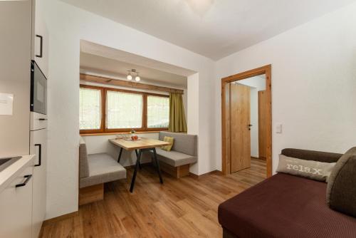 a small living room with a table and a couch at Pension Bergbauernhof Irxner in Schladming