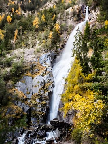 a waterfall on the side of a mountain at Schloss Gravetsch in Villandro