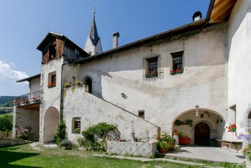 a large white building with flowers in the windows at Schloss Gravetsch in Villandro