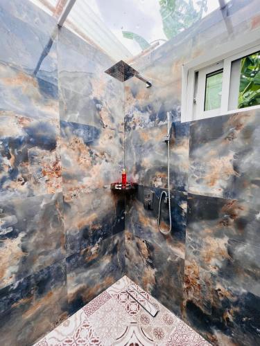 a large bathroom with a shower in a room at City Retreat Studio X in Arusha