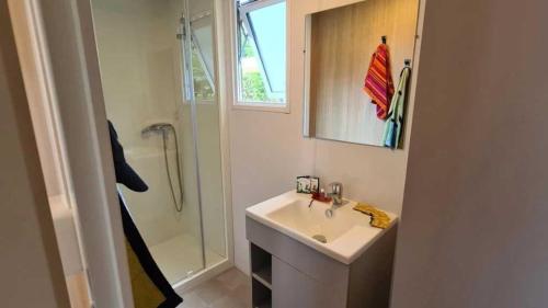 a white bathroom with a sink and a shower at Camping 4 étoiles - eebaeh in Hyères
