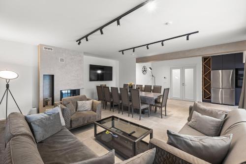 a living room with a couch and a table at Villa Salteria 3, pool, private territory, pinery in Rovinj