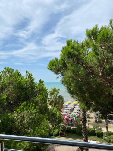 a view of a beach through some trees at Estia Seaview Apartment in Golem