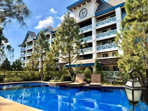 Casa Diana Pine Suites Tagaytay, Free Wi-Fi في تاجيتاي: فندق فيه مسبح وبرج ساعه