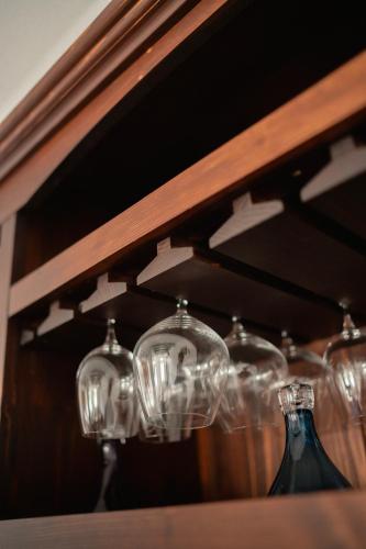 a shelf with glass jars and bottles on it at Pensiunea Cocosel in Căstău