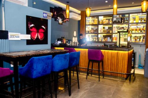 a bar with blue bar stools in a restaurant at Hotel de l'Air in Douala