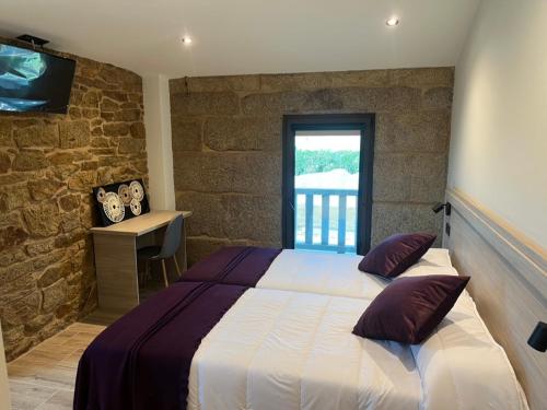 Ένα ή περισσότερα κρεβάτια σε δωμάτιο στο A Casa do Pillado