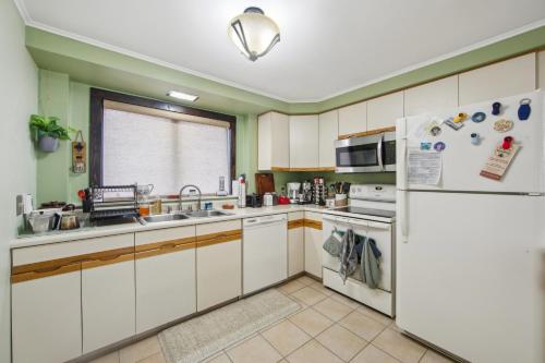 a kitchen with white cabinets and a refrigerator at Wood Lot 28C - Retreat Near Recreation Center in North Creek