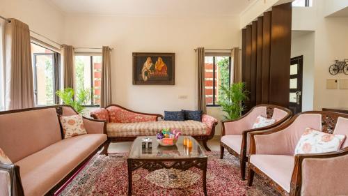 a living room with couches and a table at MiAmor by The StayCationer in Manesar