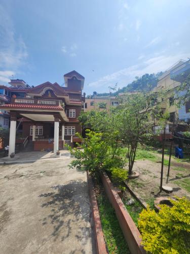 un grupo de edificios con árboles en un patio en Yadav Niwas Homestay, en Bālāju