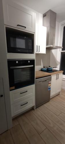 a kitchen with a stove and a microwave at Newtown Camp de Luxe in Wellington